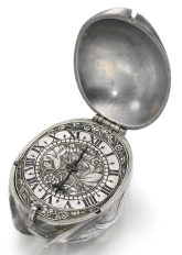 John Drake A splendid and rare silver verge watch in the form of a tulip bud, ca 1650 Gilt oval movement, verge escapement, the back-plate with pierced and floral engraved screw-on balance cock, ratchet set-up, gut line fusee Silver dial with floral engraved centre and border, polished chapter ring with Roman numerals and quarter hour divisions, single blued steel hand Silver case in the form of a Tulip bud, the pendant also of bud form • movement signed John Drake in fleet street  length including pendant 41 mm x 26 mm John Drake became a Freeman of the Blacksmiths' Company in 1605, a subscriber to the Clockmakers' Company in 1630 and was active until after 1660. He seems to have been known for his poor temper, for when, in 1654, he was forced to pay fifteen years of quarterage arrears, he referred to a Warden as a 'turd and a shitten fellow'. Cast in the form of a tulip bud, this watch reflects the fashion for this flower during the 17th century. Tulips were - and are, of course - a well-loved flower. The price of tulip bulbs boomed in the 1630s only to implode at the end of the decade. Fortunes were made and lost. The centre of 'tulipmania' market in England was at the Royal Exchange.   Sold by Sotheby’s. Private collection.