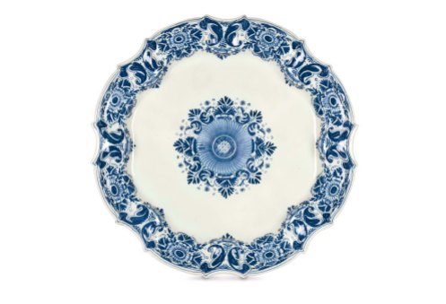 One of three large plates from Bassano, made by G.B. Antonibon, circa 1728–1738 Majolica a gran fuoco in blue monochrome Diameter: 45 cm Circular body with flat base, multilinear scalloped and convex edges, outer border lightly ribbed. Delft-type decoration (also know as “bull’s eye”) featuring large flowers and highly stylised leaves arranged radially along the edges. In the centre, a star-shaped corolla pattern with stylised leaves. Private Collection.